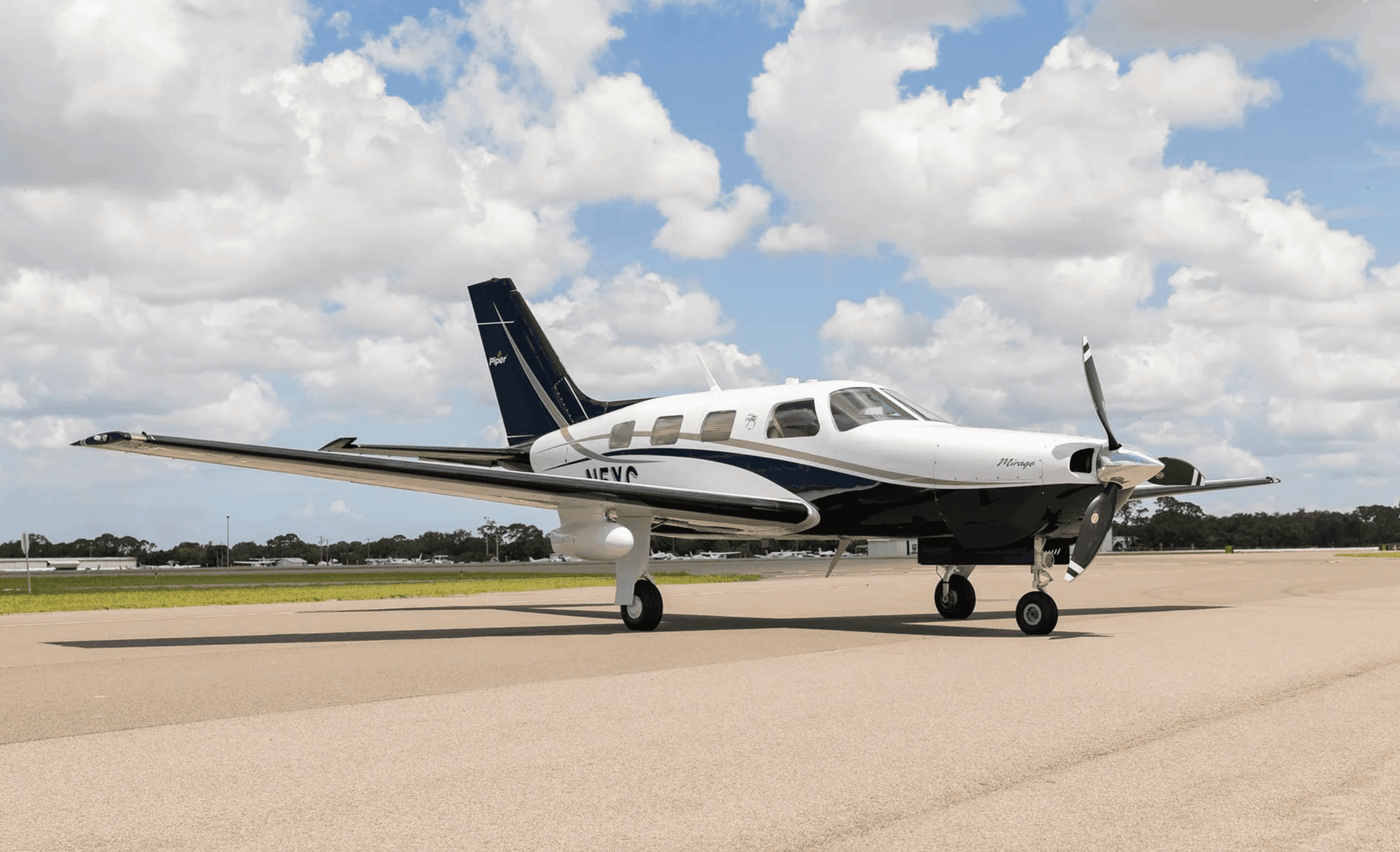 Piper Malibu aircraft on the ramp under a bright sky